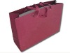 red paper bag with red handle